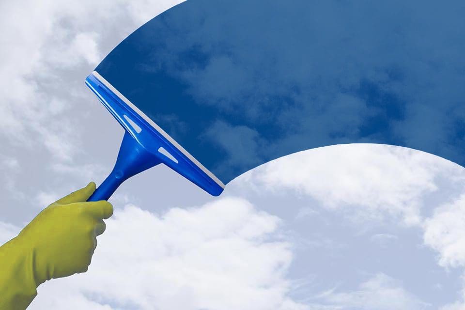 window cleaning with blue sky behind squeegee