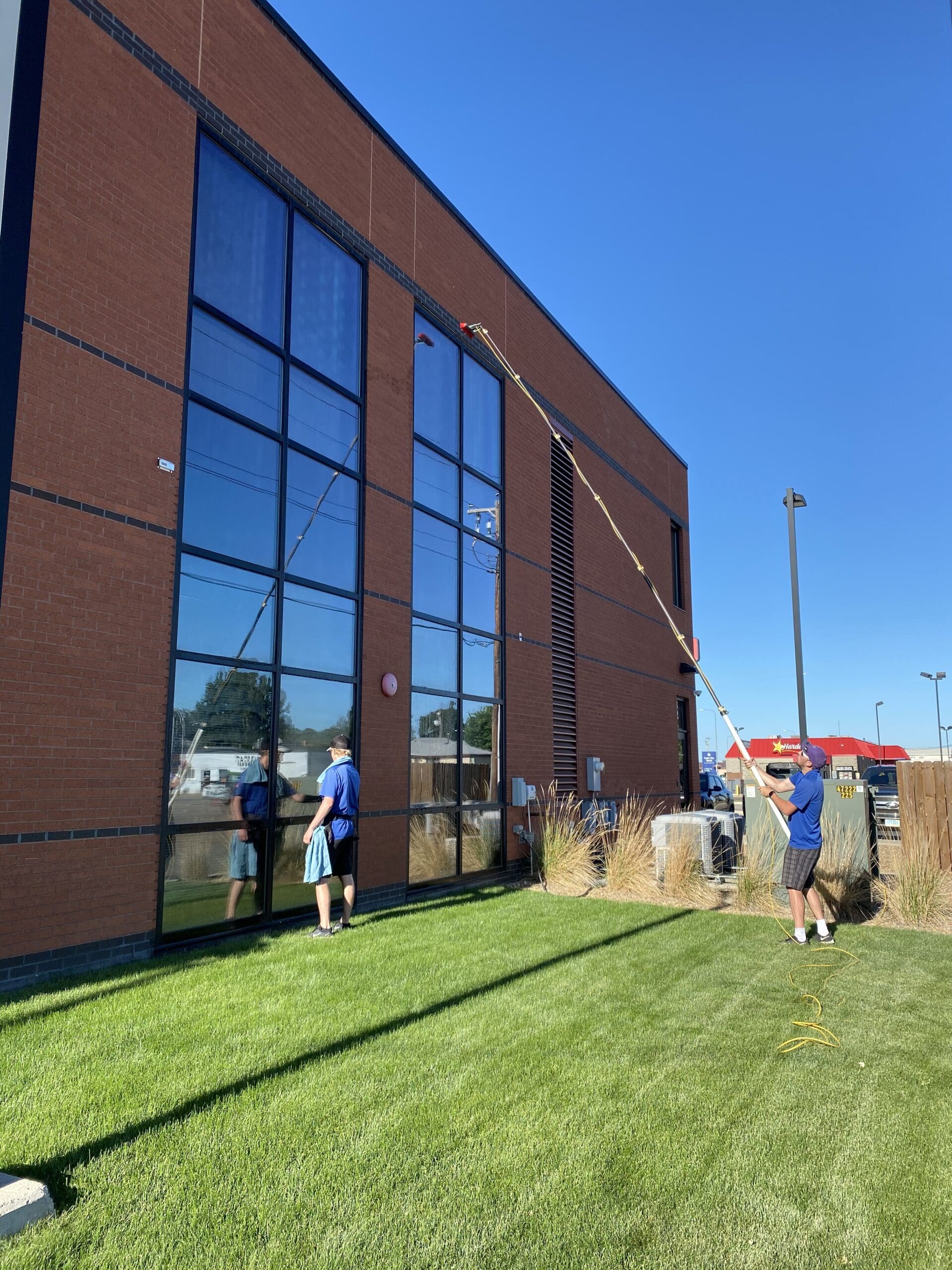 Window Cleaners in Bismarck cleaning tall building windows.
