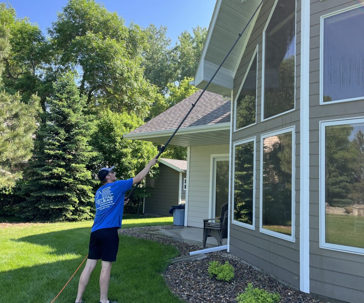 Crystal Clear Professional cleaning residential window in North Dakota.